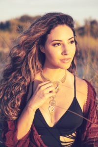 Young woman looks off towards the sunset