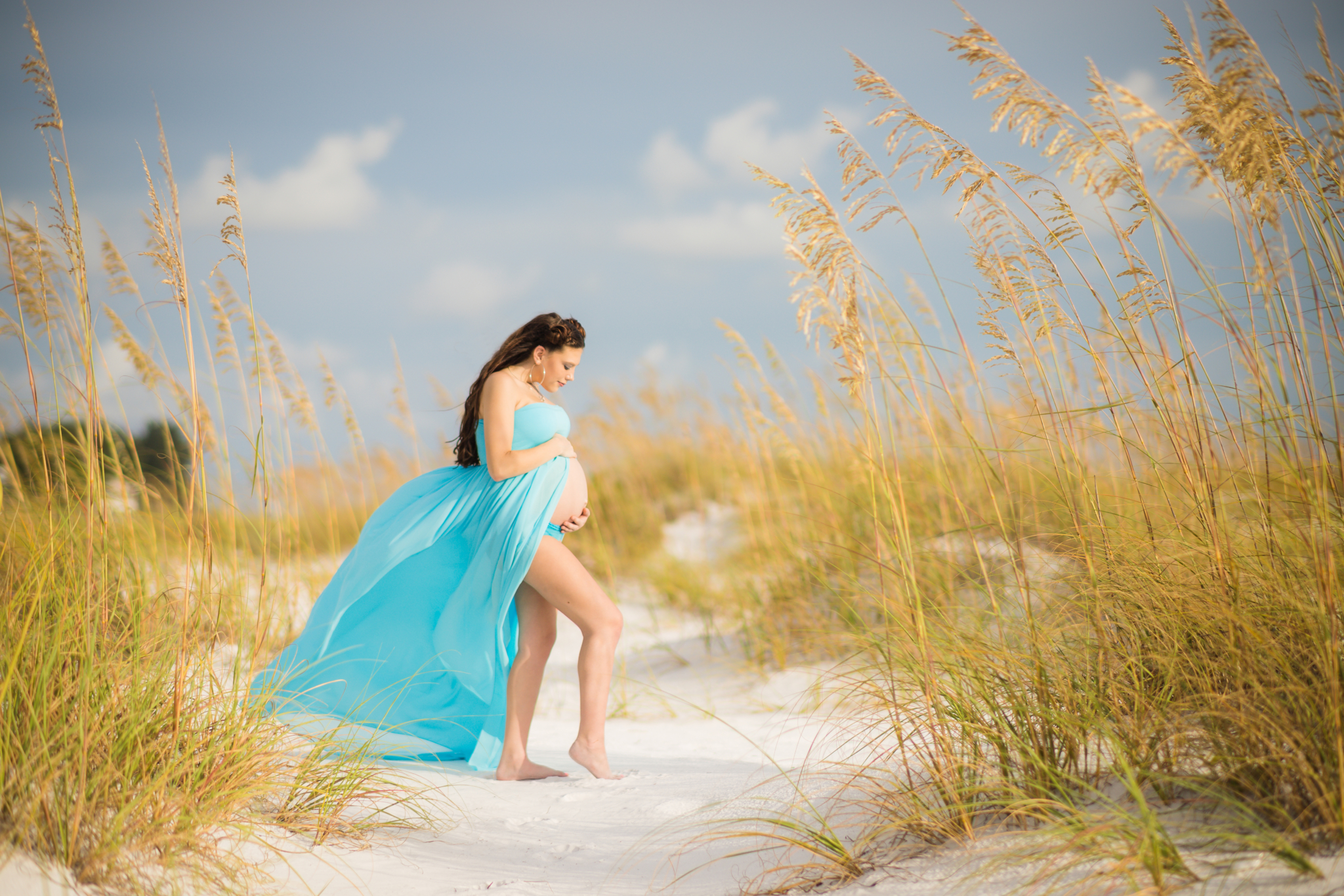 young woman's maternity photo at Anna Marie Island at sunset