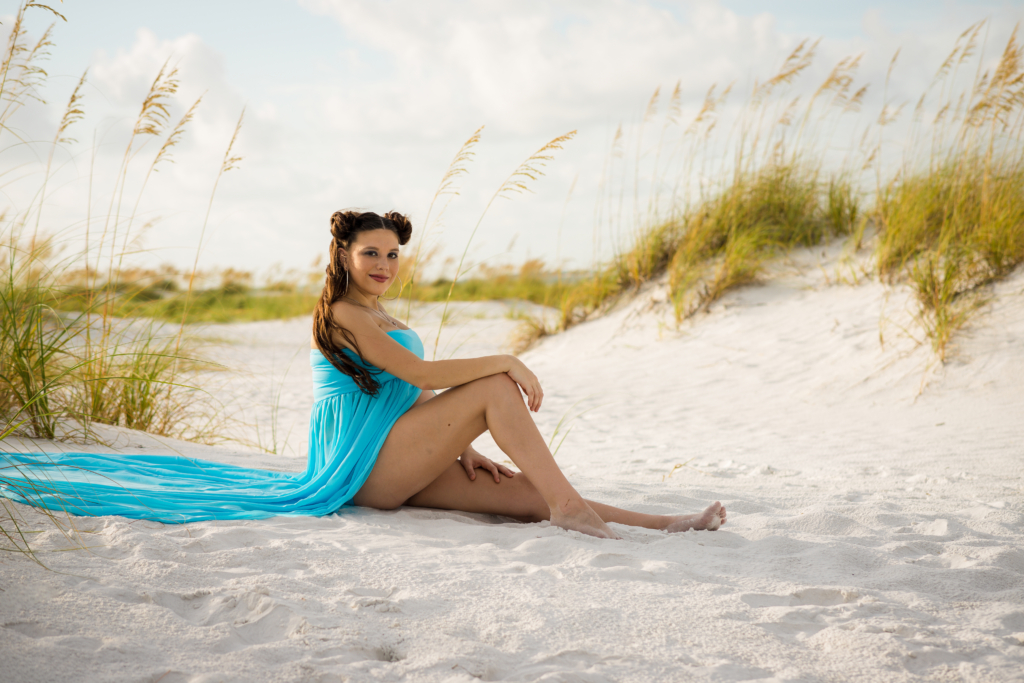 young woman's maternity photo at Anna Marie Island at sunset