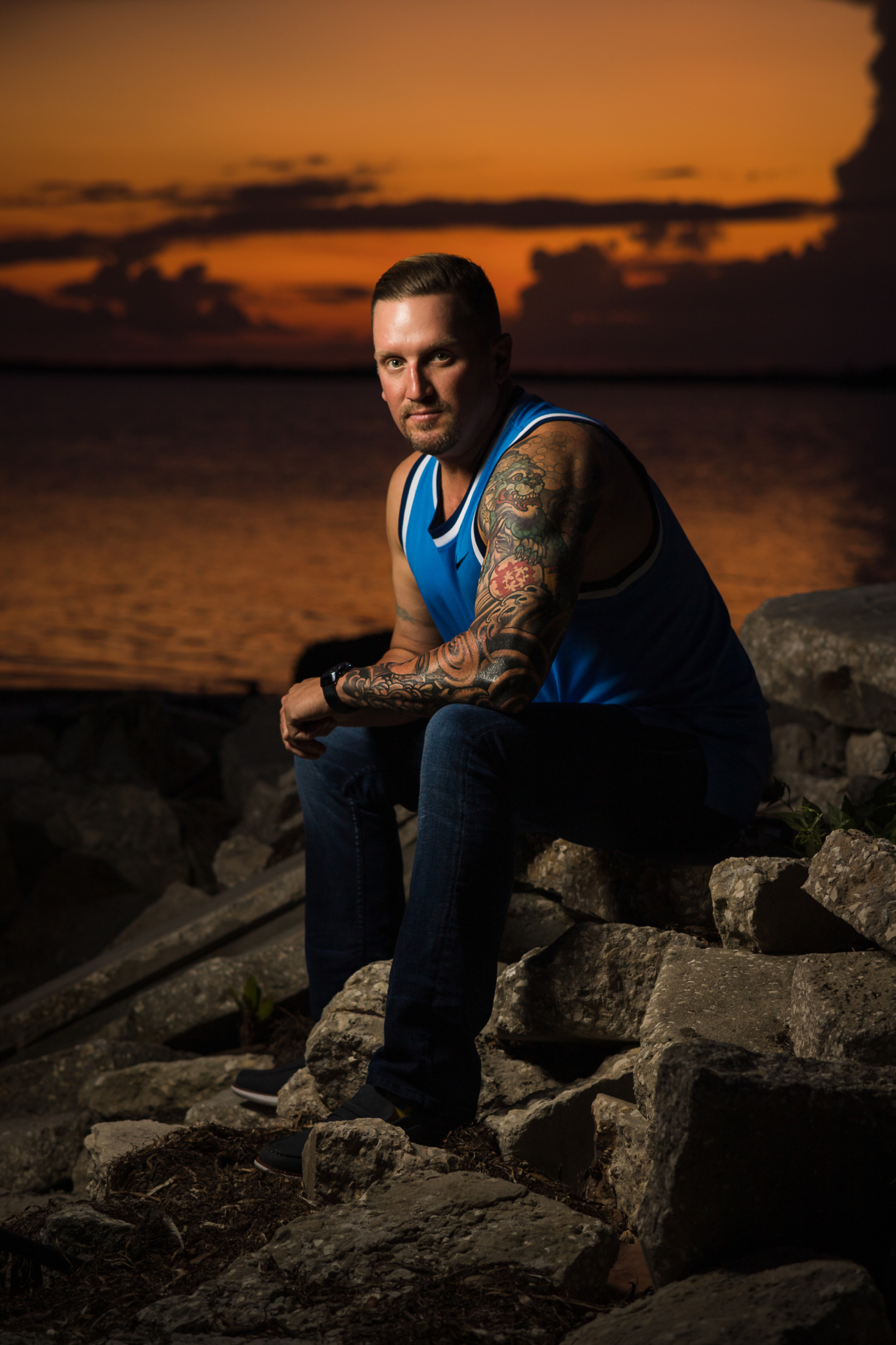 man sits in front of a Dunedin sunset